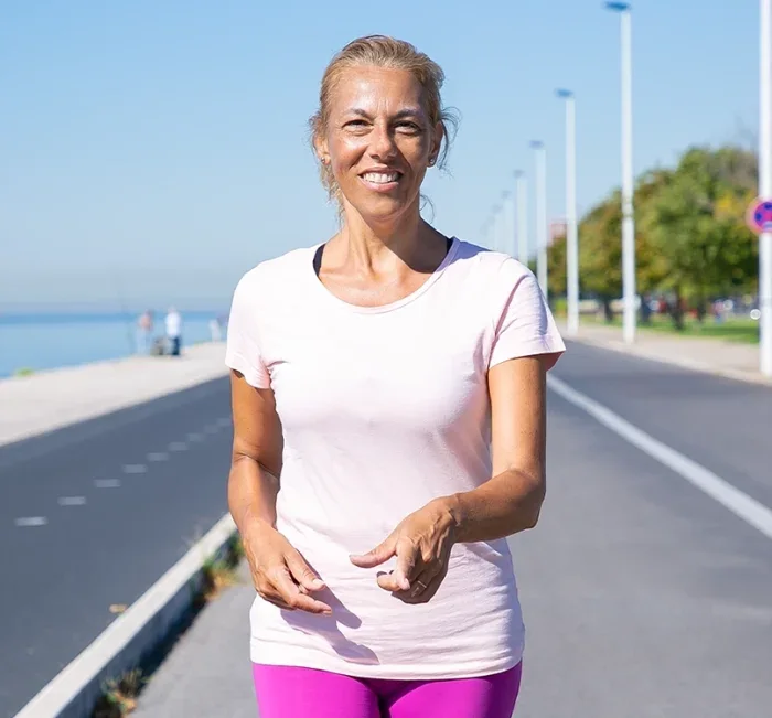 Active woman standing outdoors after a daily walk